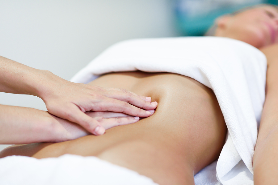 woman having postnatal massage on tummy ma